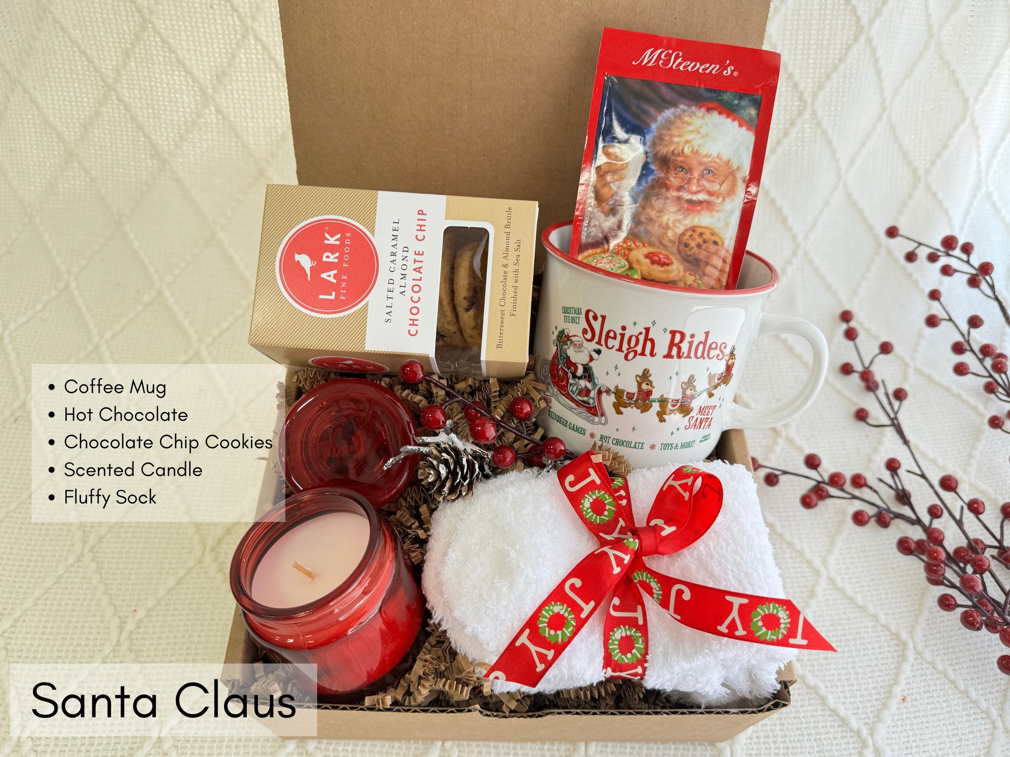 Santa Claus Gift Box featuring white fluffy socks, Christmas coffee mug, scent candle, gourmet cookie, and hot chocolate.