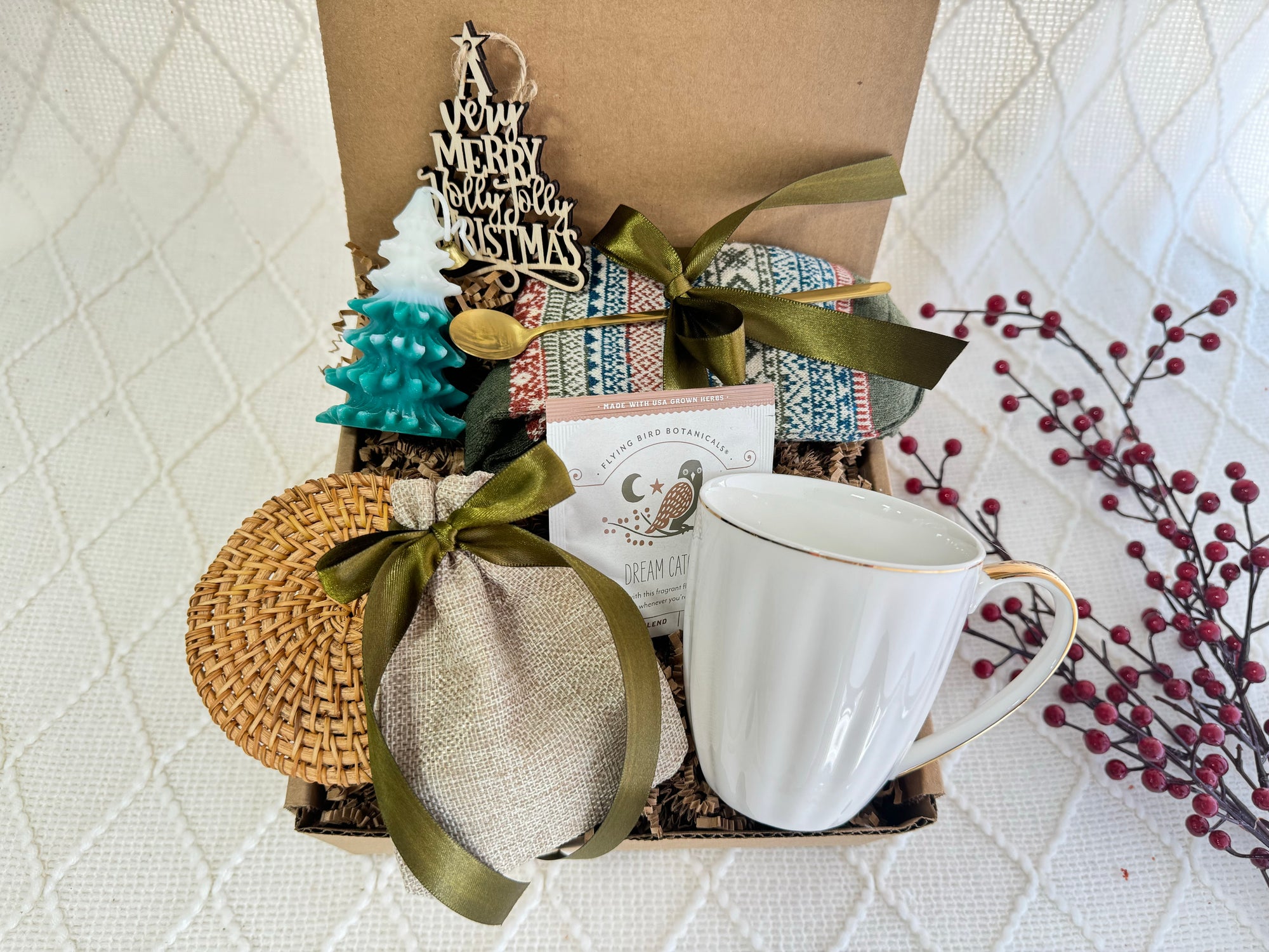 Silent Night Gift Box featuring Nordic socks, coffee mug, herbal tea, burlap bag, wooden Christmas ornament, golden coffee spoon, Christmas tree candle, caramel candy, and coaster.