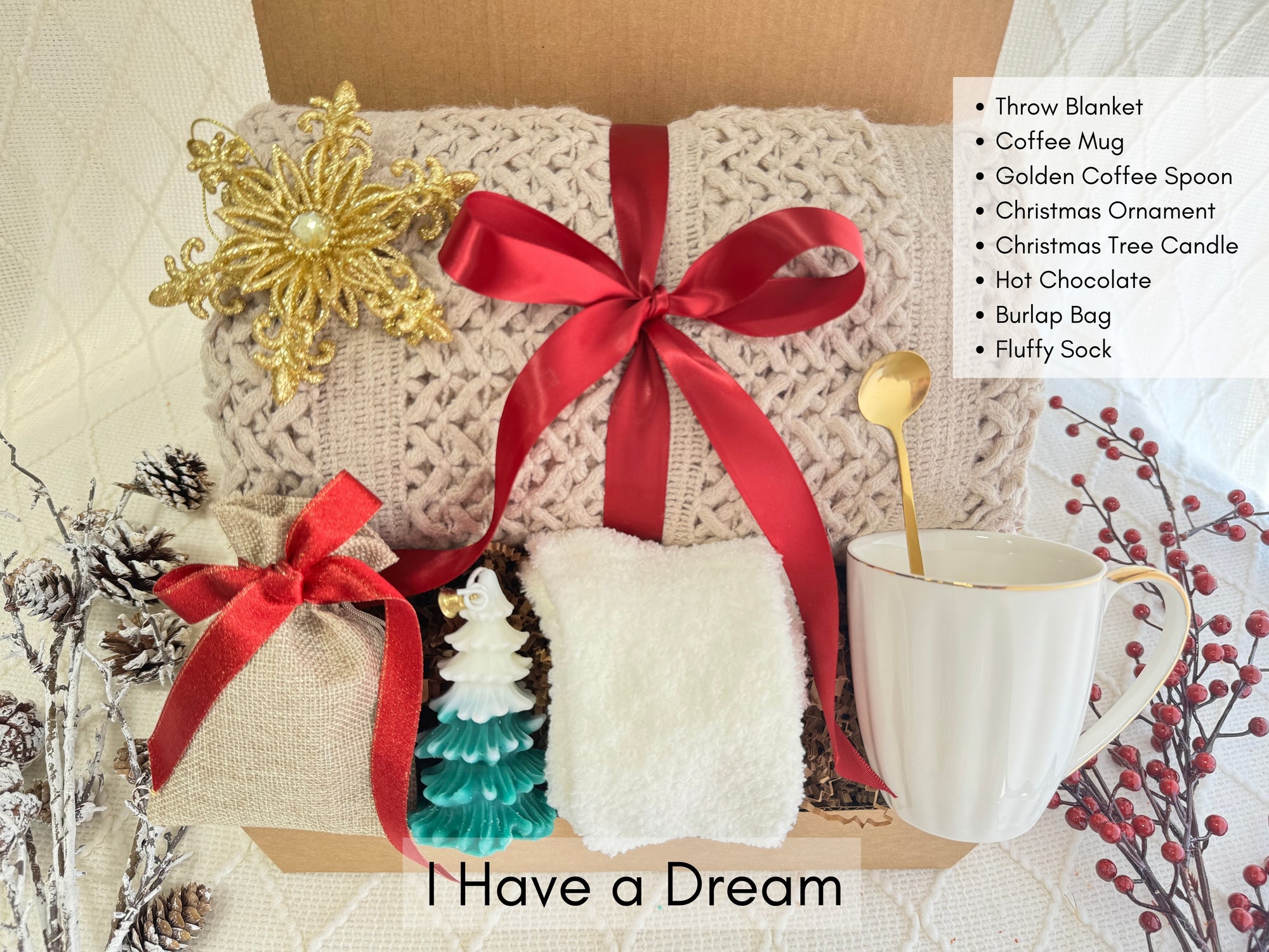 I Have a Dream Gift Box featuring a throw blanket, white fluffy socks, coffee mug, Christmas tree candle, snowflake Christmas ornament, golden coffee spoon, hot chocolate, and burlap bag.